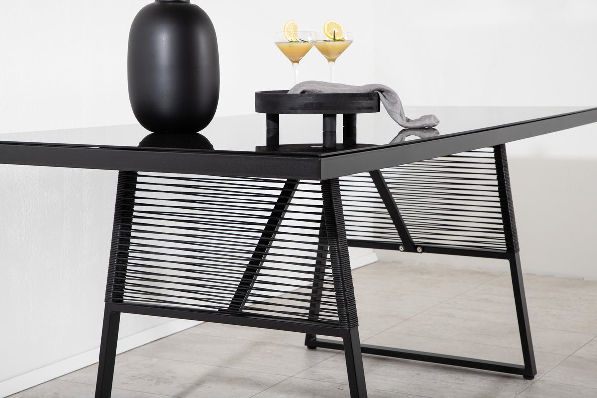 Garden table Kaoni - a combination of black steel and dark glass top